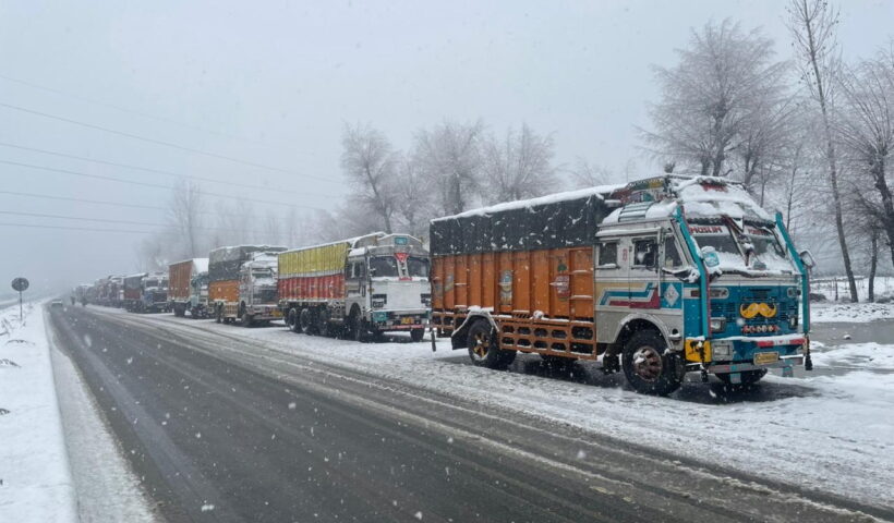 Srinagar: Trucks parked as Jammu-Srinagar national highway road closed due to snow accumulation near Qazigund in Jammu and Kashmir on thursda