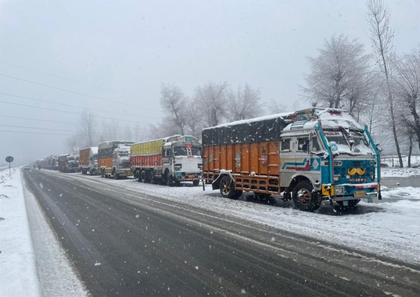 Srinagar: Trucks parked as Jammu-Srinagar national highway road closed due to snow accumulation near Qazigund in Jammu and Kashmir on thursda