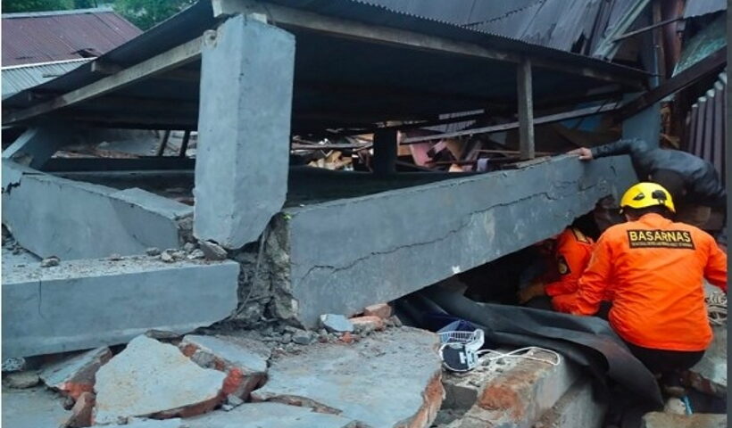 Members of the Search and Rescue (SAR) team search in a damaged building after a 6.2-magnitude earthquake hit Mamuju, West Sulawesi, Indonesia