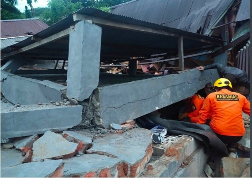 Members of the Search and Rescue (SAR) team search in a damaged building after a 6.2-magnitude earthquake hit Mamuju, West Sulawesi, Indonesia