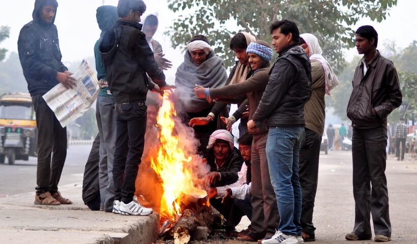 Jaipur: People warm themselves around a fire on a cold winter morning in Jaipu