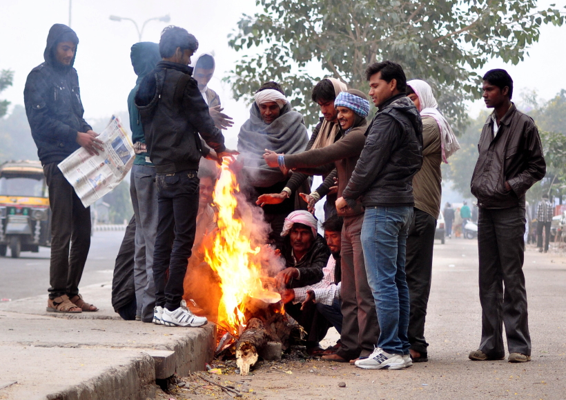 Jaipur: People warm themselves around a fire on a cold winter morning in Jaipu