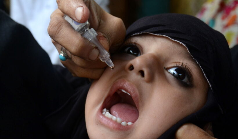 LAHORE, Oct. 24, 2016 (Xinhua) -- A Pakistani health worker gives a polio vaccine to a child on World Polio Day in eastern Pakistan's Lahore, Oct. 24, 2016. The World Polio Day was observed across the globe on Monday with renewed pledge to work with more dedication in enhancing awareness about the hazards of the crippling disease