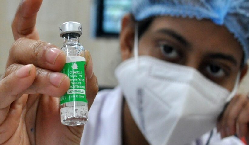 Kolkata:A health worker shows a vial of Covishield vaccine before administering the same to an elderly man at a government hospital in Kolkata