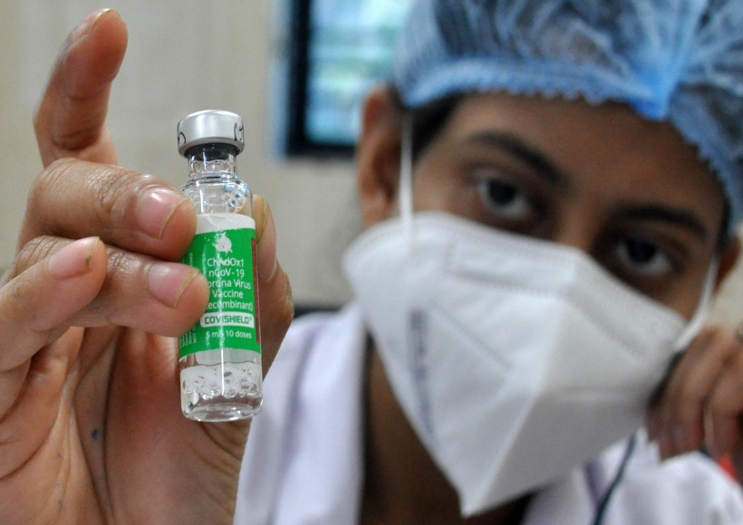 Kolkata:A health worker shows a vial of Covishield vaccine before administering the same to an elderly man at a government hospital in Kolkata