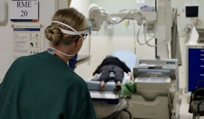 Medical workers carry a patient into a hospital in New York, the United States