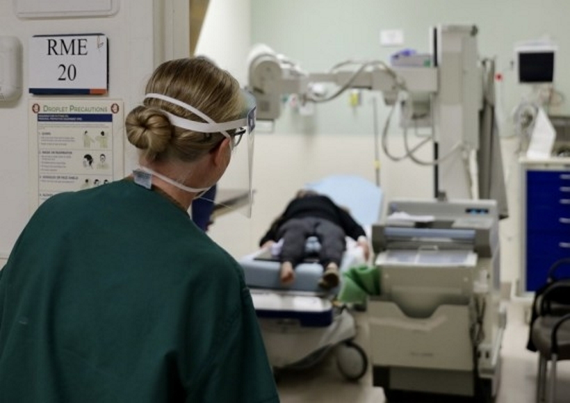 Medical workers carry a patient into a hospital in New York, the United States