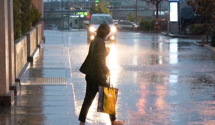 California: A pedestrian walks in storm in Millbrae, California, the United States, Jan. 4, 2023. A winter storm hit northern California, bringing rain and snow to the local area