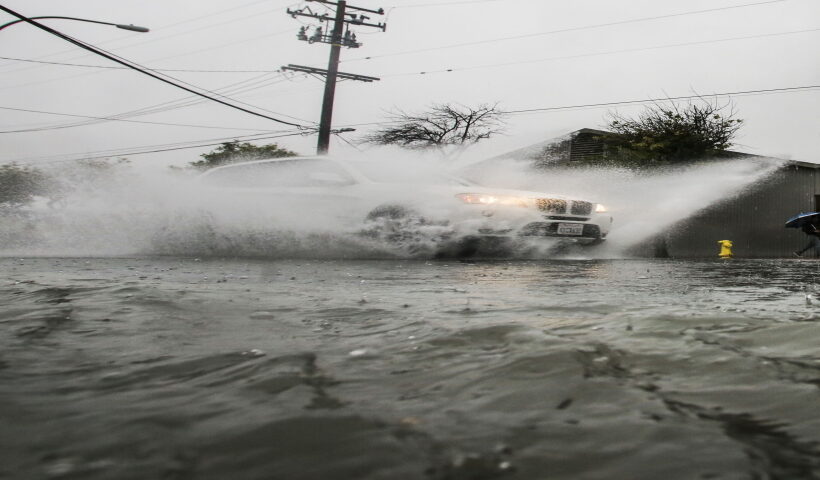 LOS ANGELES, Jan. 6, 2016 (Xinhua) -- A vehicle plows through a flooded street in Alhambra near Los Angeles, California, the United States, on Jan. 5, 2016. El Nino storms lined up in the Pacific, promising to drench parts of the western U.S. for more than two weeks and increasing fears of mudslides and flash floods in regions stripped bare by wildfires.