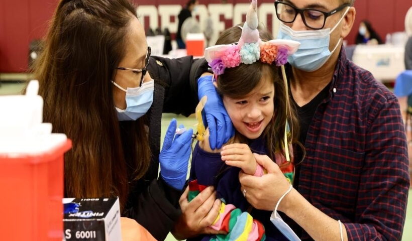 A child receives a COVID-19 vaccine shot in Los Angeles, the United States
