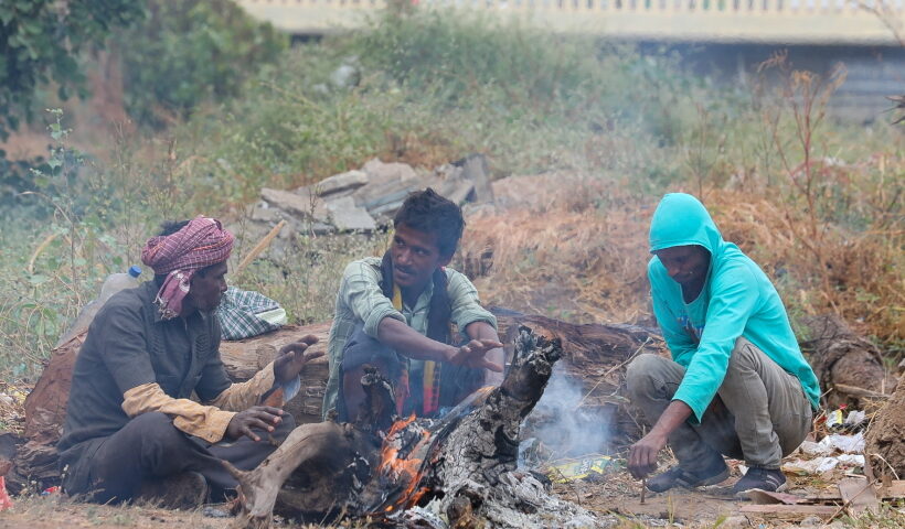 Ahmadabad :People warm themselves near a bonfire to protect from cold in Ahmedabad