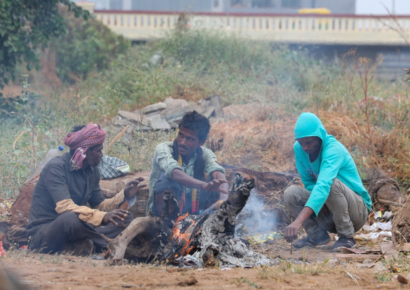 Ahmadabad :People warm themselves near a bonfire to protect from cold in Ahmedabad