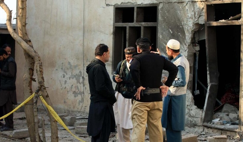 Security personnel inspect a police check-post following a terrorist attack in Pakistan's northwest Khyber Pakhtunkhwa