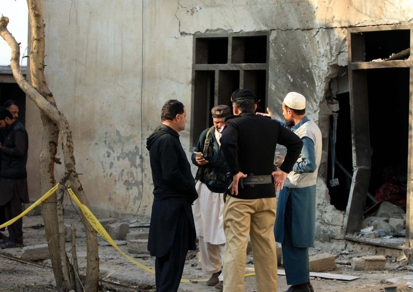 Security personnel inspect a police check-post following a terrorist attack in Pakistan's northwest Khyber Pakhtunkhwa