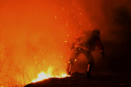 A firefighter battles a wildfire