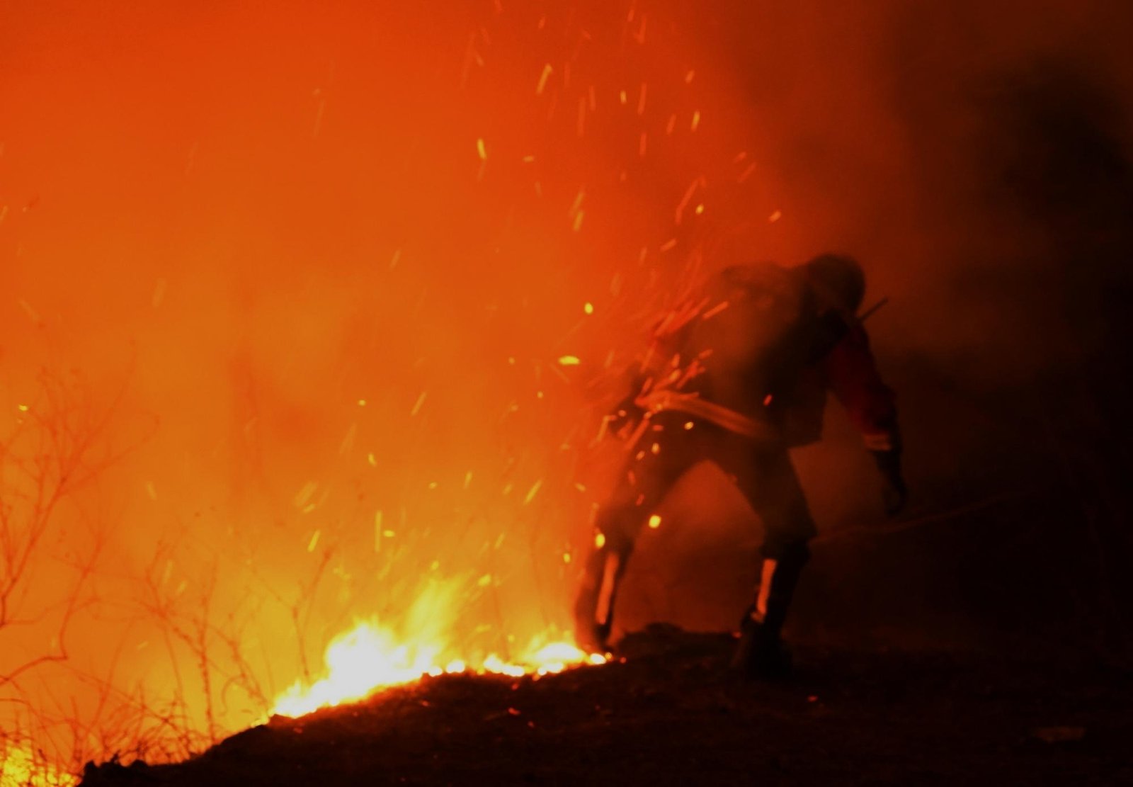 A firefighter battles a wildfire