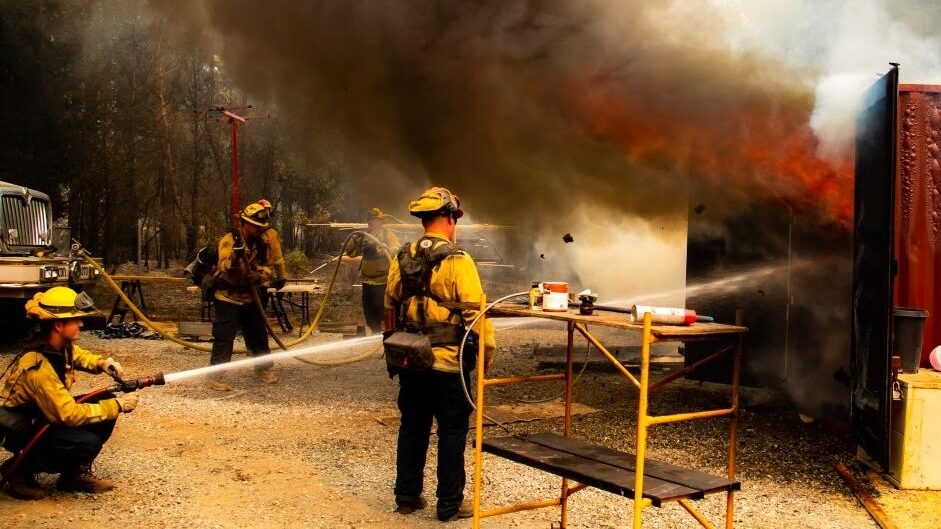 Firefighters attempt to extinguish a fire