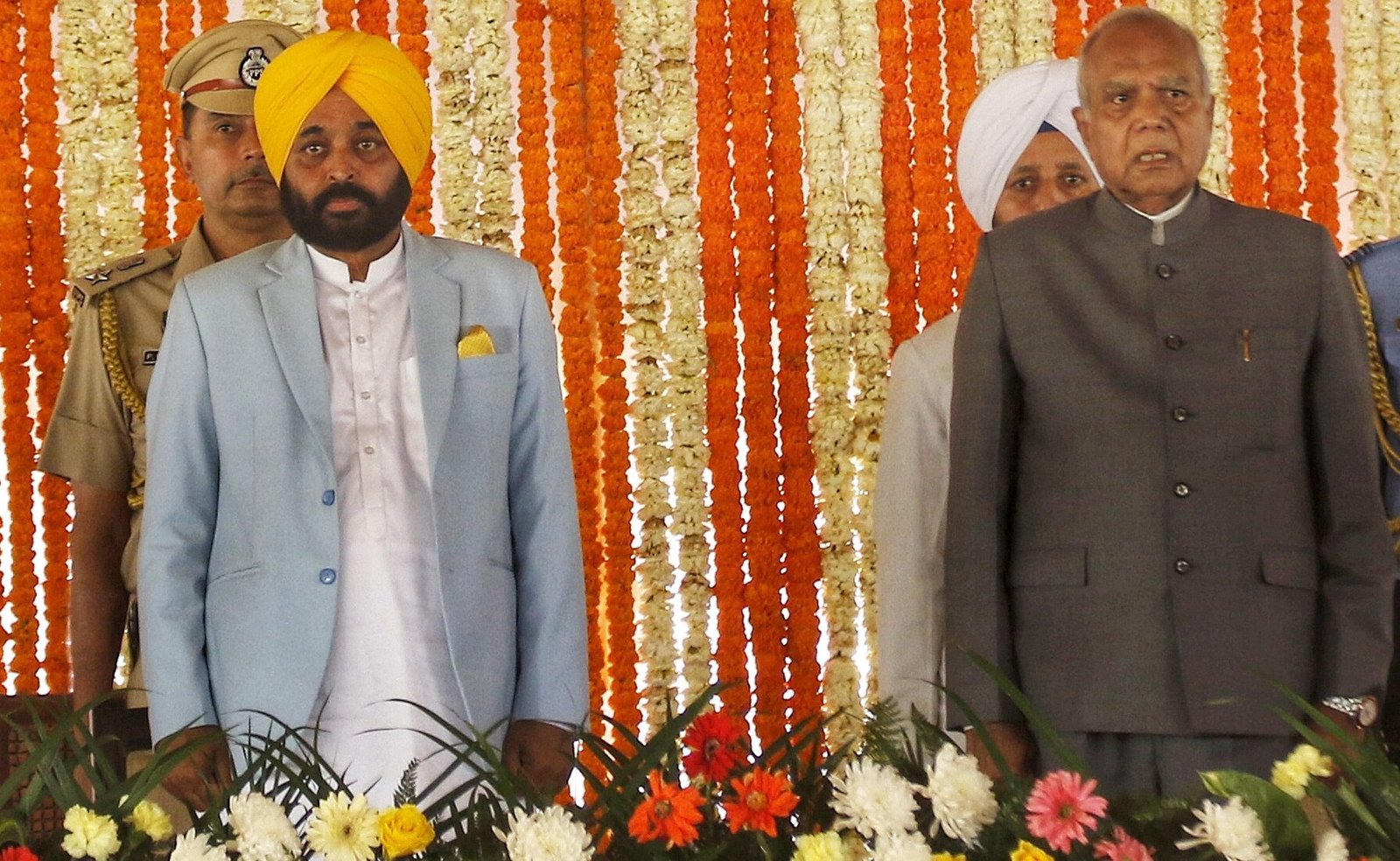 AAP leader Bhagwat Mann with Punjab Governor Banwarilal Purohit during his oath taking ceremony