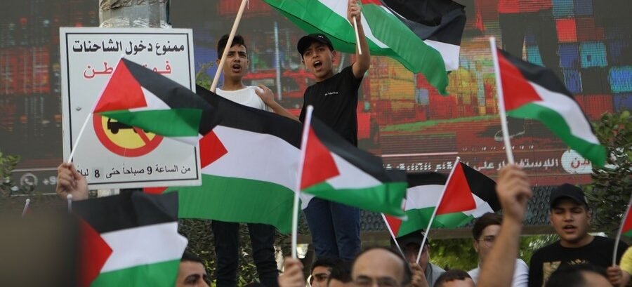 Palestinian people protest against the flag march in East Jerusalem