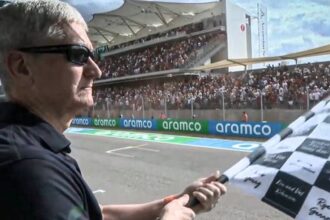 Apple CEO Tim Cook checkered flag at Formula one GP