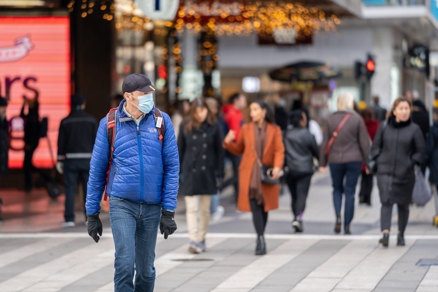 A man wearing a face mask walks in the street during the COVID-19 pandemic in Stockholm