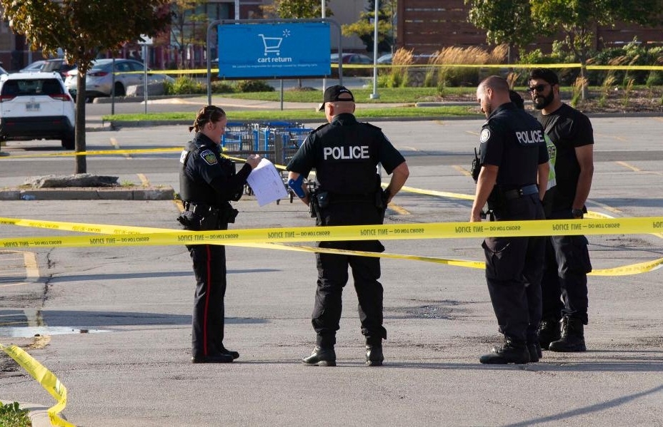 Police officers are seen at the scene investigating on the double shootings in Mississauga