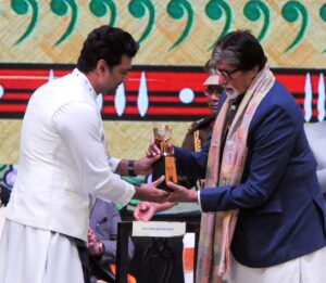 Veteran actor Amitabh Bachchan presents an award during the inauguration of 28th Kolkata International Film Festival at Netaji Indoor Stadium in Kolkata