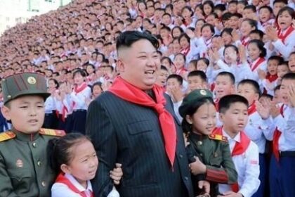 North Korea's leader Kim Jong-un posing for a photo with members of the Korean Children's Union at the organization's 8th congress that month