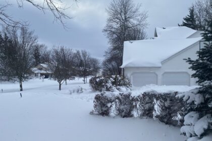 Heavy snow blankets the court yard of a house and surrounding areas in Amherst