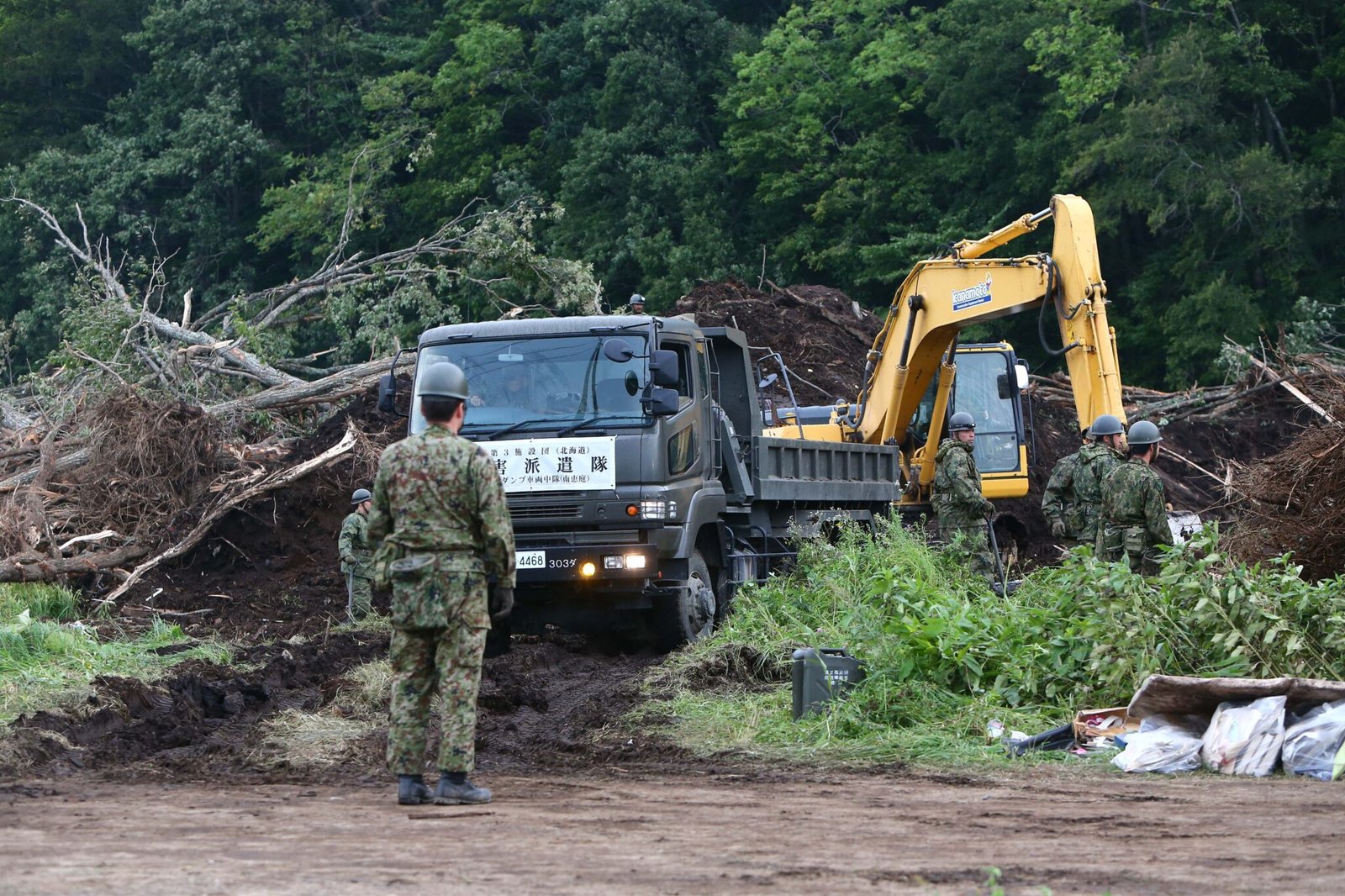 Rescue members operate excavator