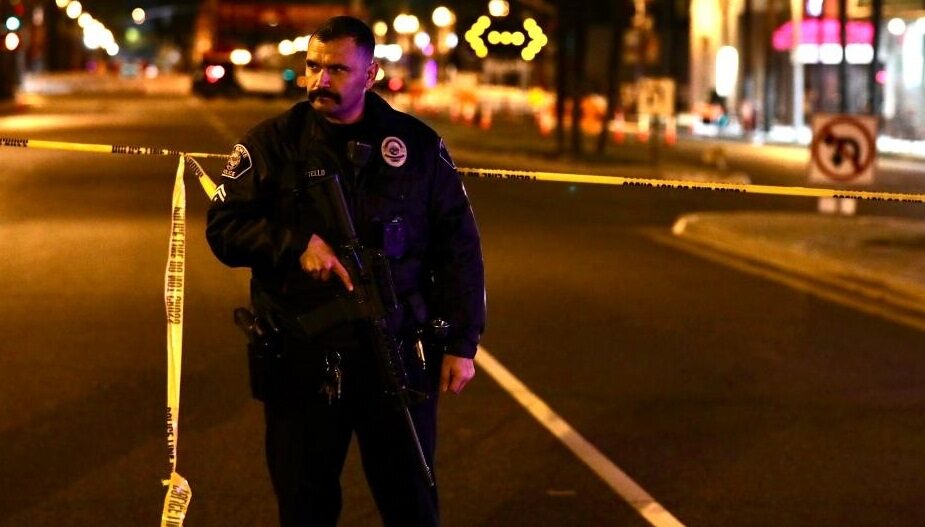 A police officer stands guard on the scene of a mass shooting