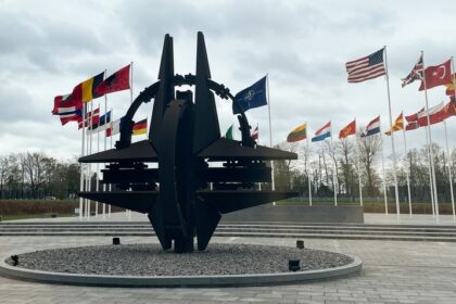 A sculpture and flags at NATO headquarters in Brussels