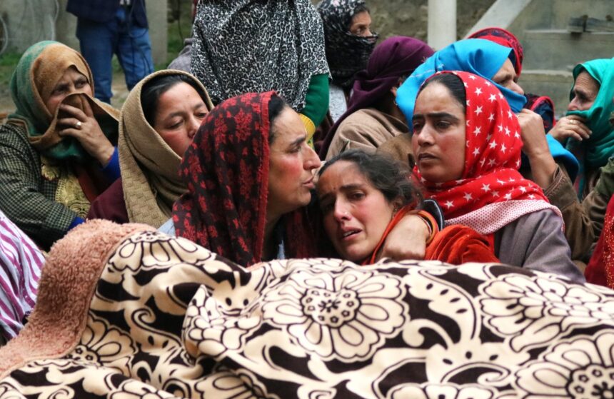 Relatives and neighbours mourn near the body of Sanjay Sharma a Kashmiri Pandit during his funeral