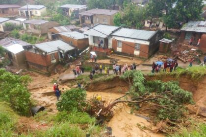 People gather in an area damaged in floods in Blantyre, Malawi