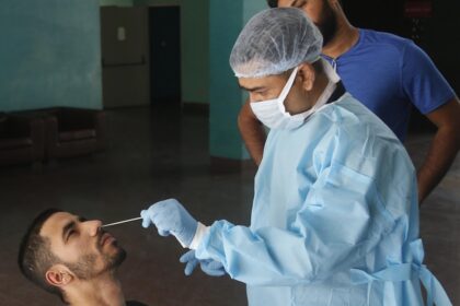 A health worker collects a nasal sample