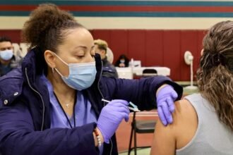 A health worker administers a flu vaccine