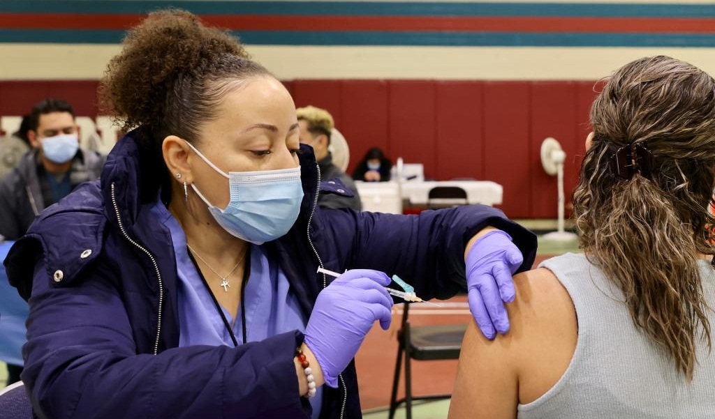 A health worker administers a flu vaccine