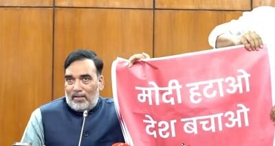 Delhi Environment Minister Gopal Rai shows a poster that reads 'Modi Hatao, Desh Bachao'
