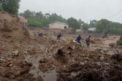 People walk in the mud in Chilobwe