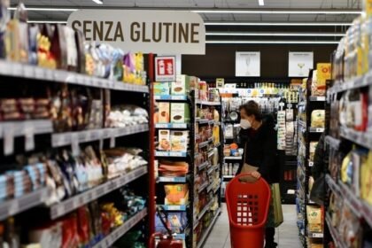 A customer shops at a supermarket in Rome