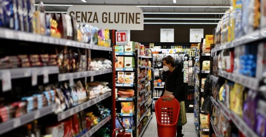 A customer shops at a supermarket in Rome