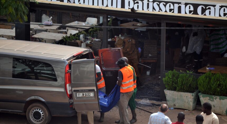 Rescuers transfer remains of the victims of an attack