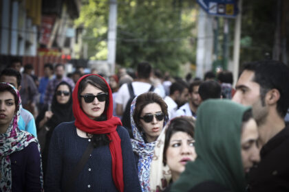 Iranian women walk on a street in downtown Tehran