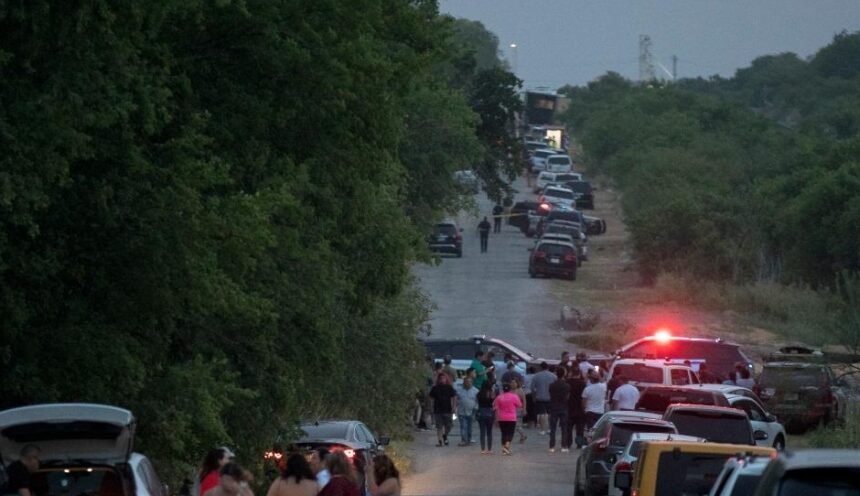 People gather at the scene of an alleged human smuggling mass