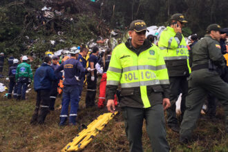 Security members inspect the site of the crashed plane