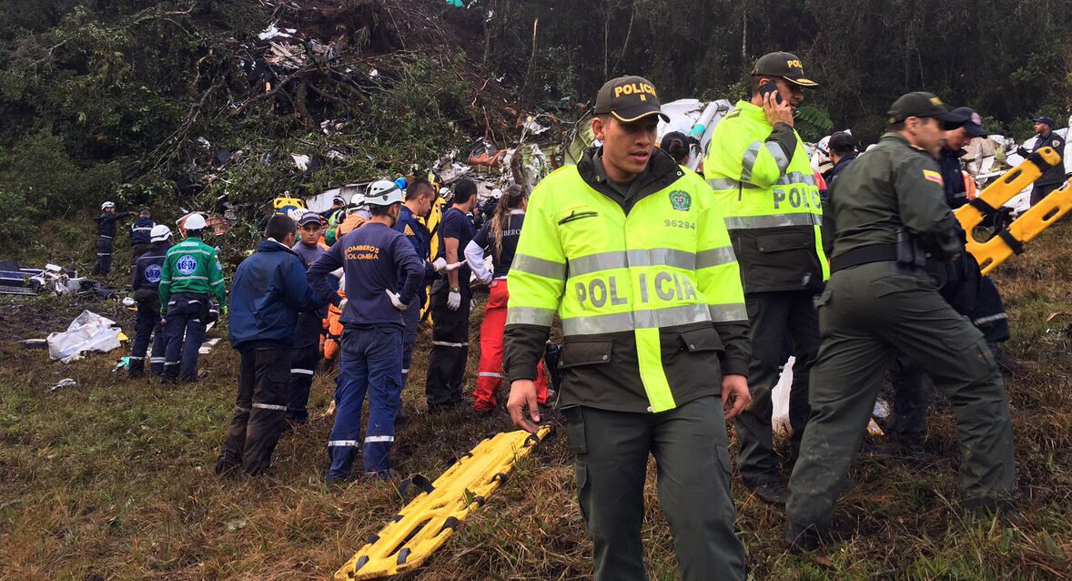 Security members inspect the site of the crashed plane