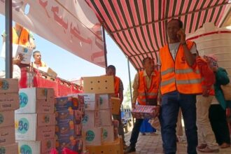 Staff members prepare supplies for refugees from Sudan