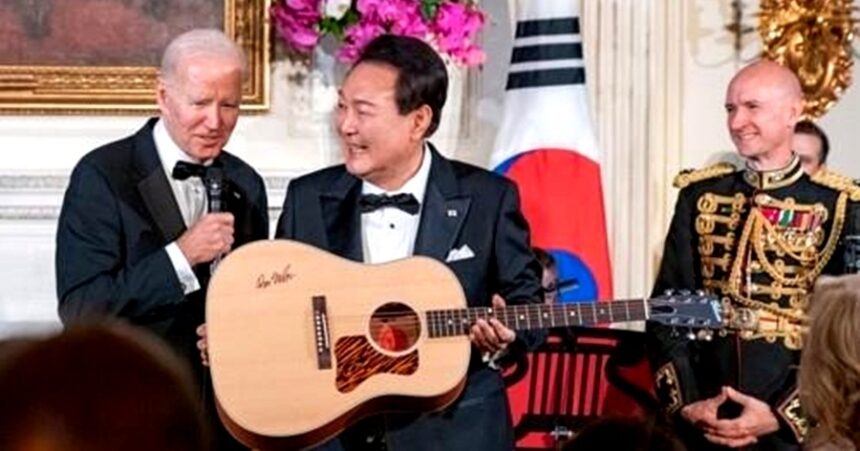 U.S. President Joe Biden (L) gifts South Korean President Yoon Suk Yeol