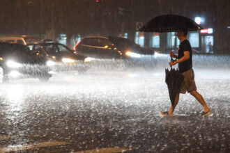 A citizen walks at a rainy night in Beijing