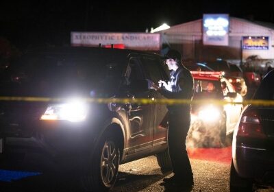 A sheriff deputy works at the scene of a shooting in Half Moon Bay in California